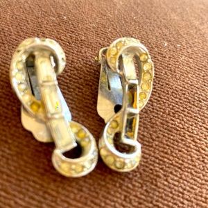 1950s rhodium and rhinestone clip earrings. Missing some stones